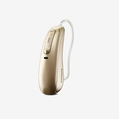 A beige Phonak hearing aid with a slim design and thin, clear tubing, displayed on a plain white background.